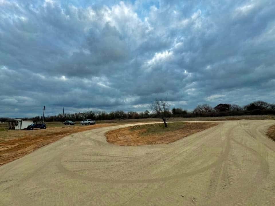 Shaped ranch driveway across open pasture